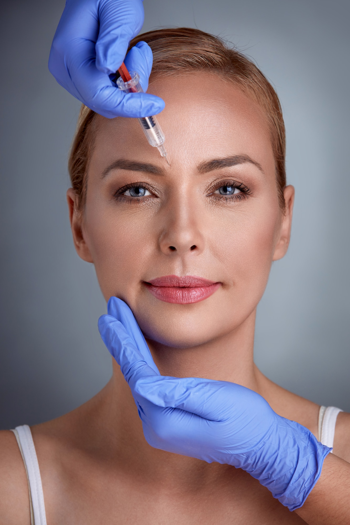 Lady getting face treatment of botox