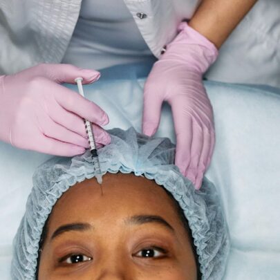 woman receiving injection in her forehead by trained medical professional